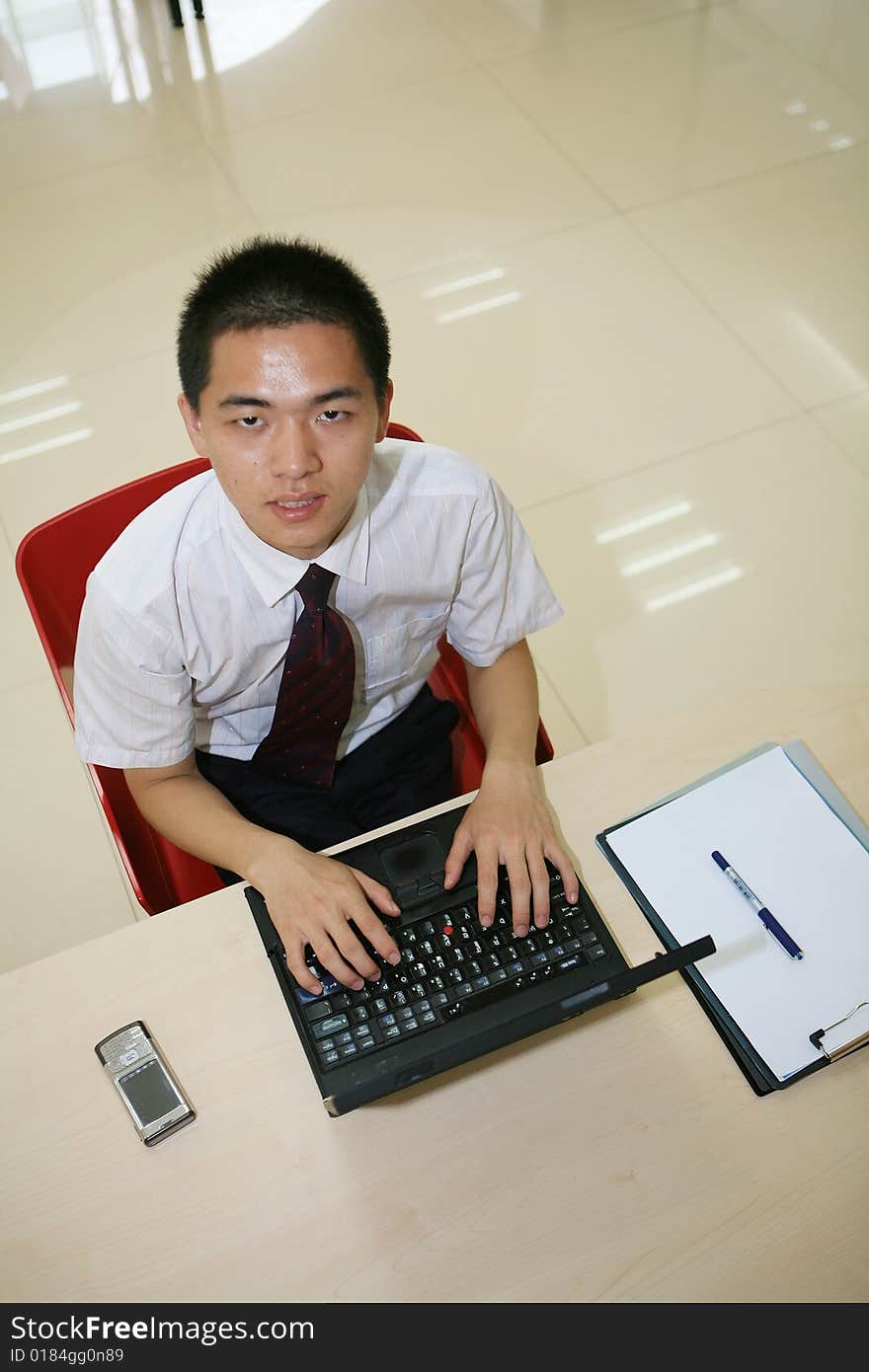 Young asian businessman in his office