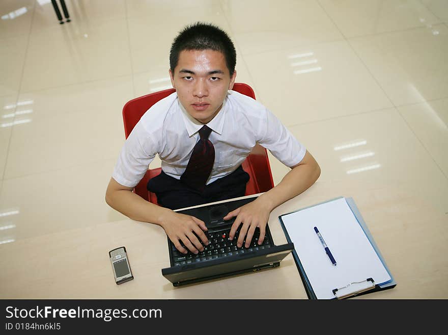 Young asian businessman in his office