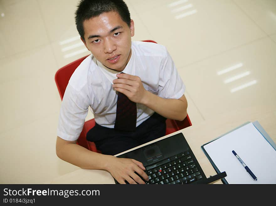 Young asian businessman in his office