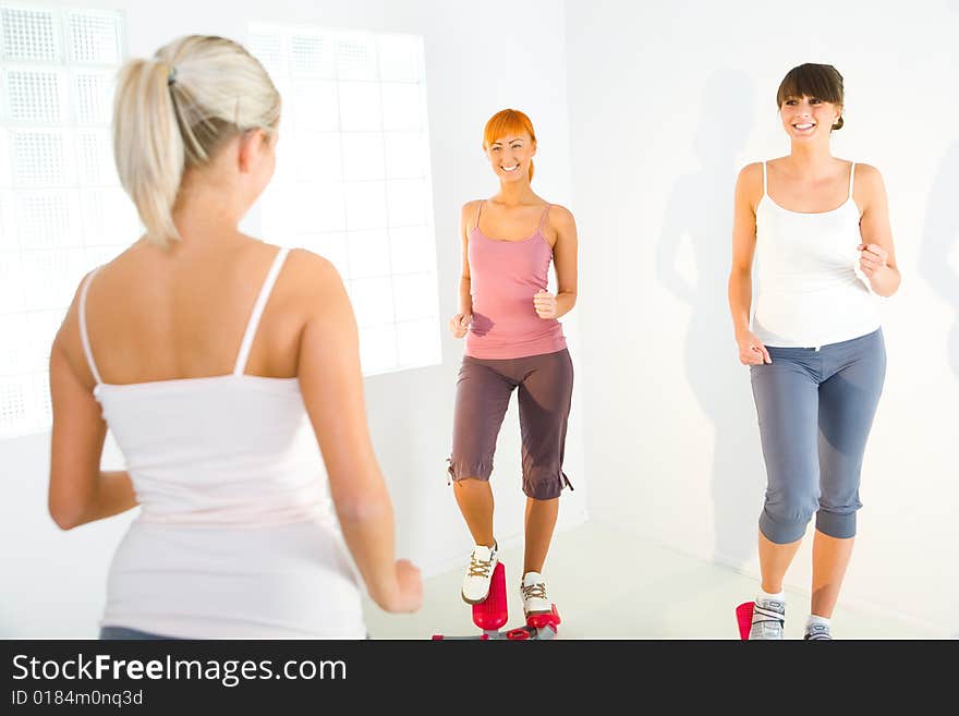 Women exercising on stepping machine