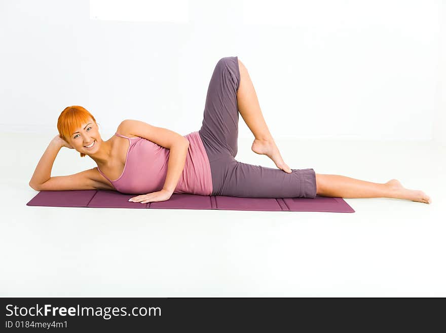 Woman exercising on mat