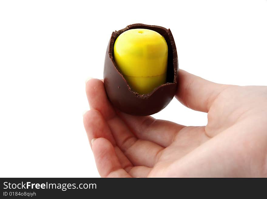 An Isolated to White photo of a mini Easter Egg with toy inside, almost eaten. An Isolated to White photo of a mini Easter Egg with toy inside, almost eaten