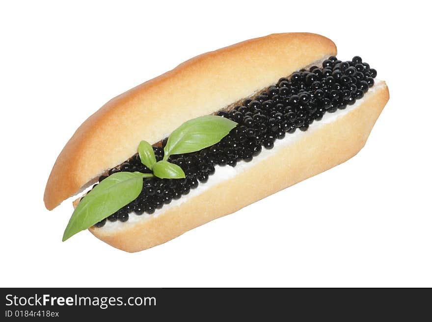 White bread with black caviar and basil