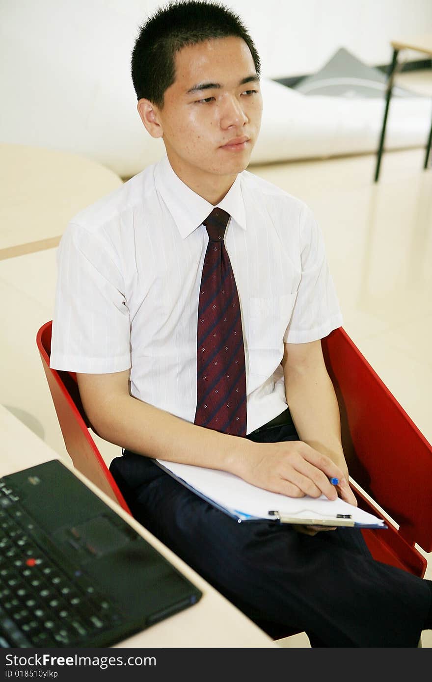 Young asian businessman in office