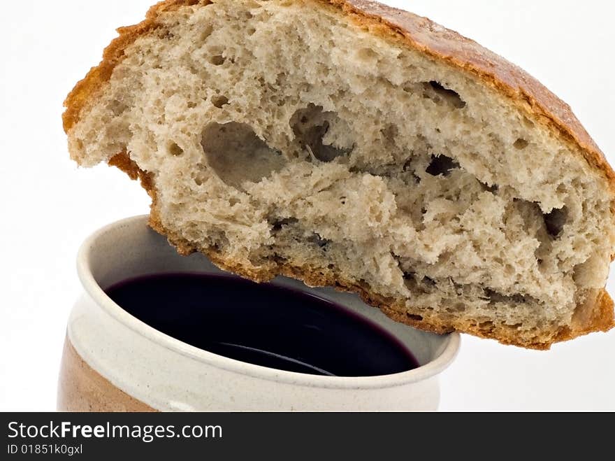 Red wine and bread - communion on the white background