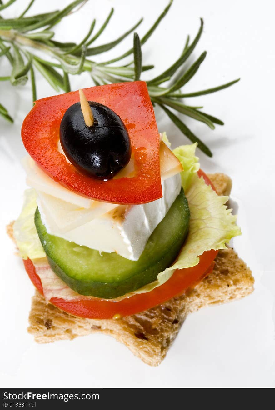 Star sandwich with cheese and vegetables on a white plate