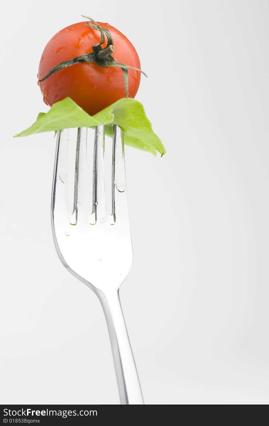 Fork with Fresh Salad isolated over white background. Fork with Fresh Salad isolated over white background