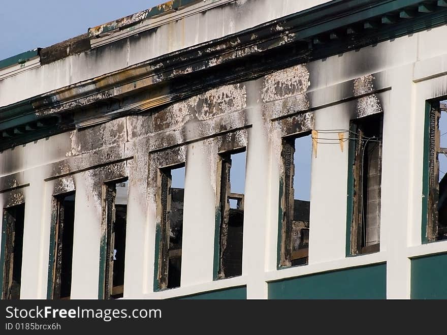 Charred remains of a fire damaged restaurant. Burnt char and soot with signs of smoke damage. Charred remains of a fire damaged restaurant. Burnt char and soot with signs of smoke damage.