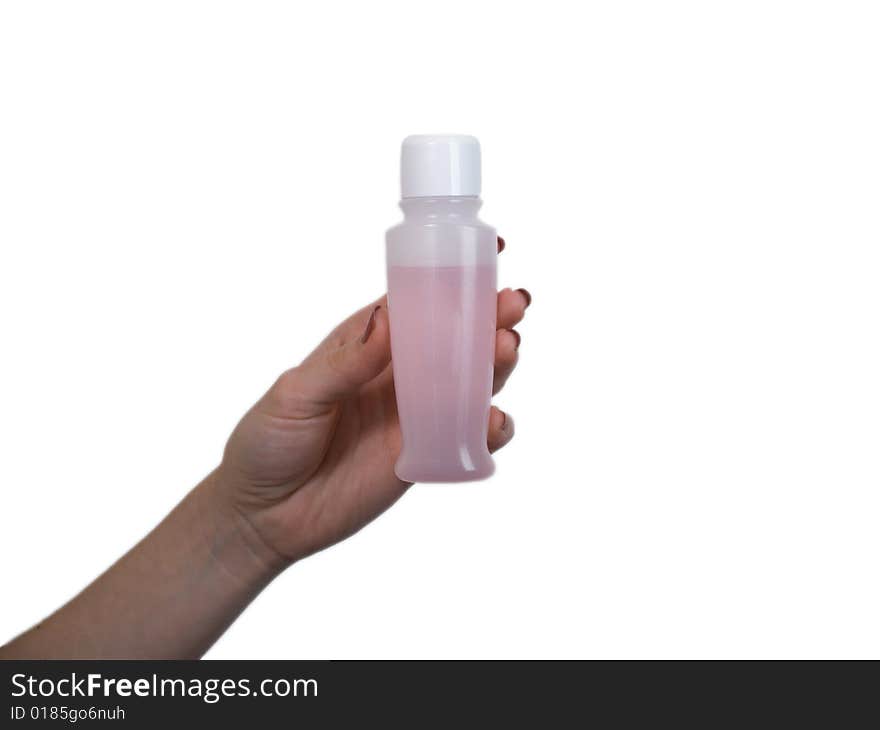 The female hand holds on an open palm a small bottle with perfumery on a white background. The female hand holds on an open palm a small bottle with perfumery on a white background