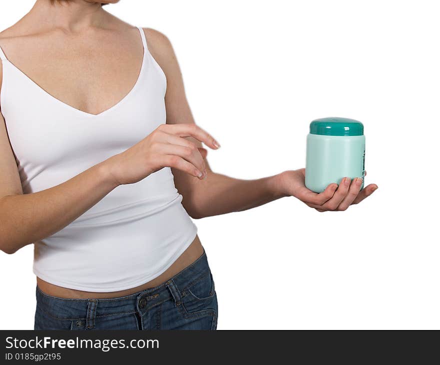 The girl in jeans and a vest holds in a hand a small bottle with perfumery means. The girl in jeans and a vest holds in a hand a small bottle with perfumery means