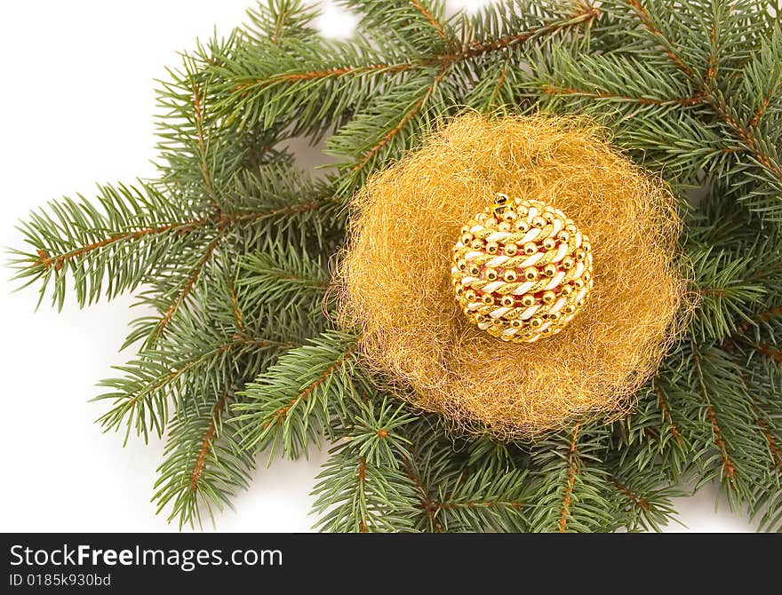 New Year's sphere in jack from gold on green fur-tree branches