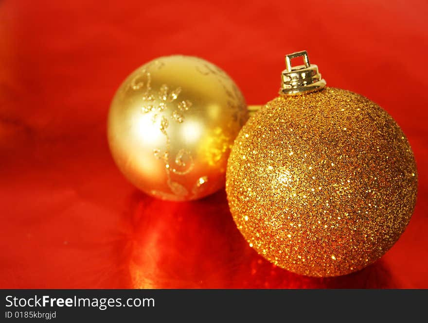 Golden Christmas ornament on red background