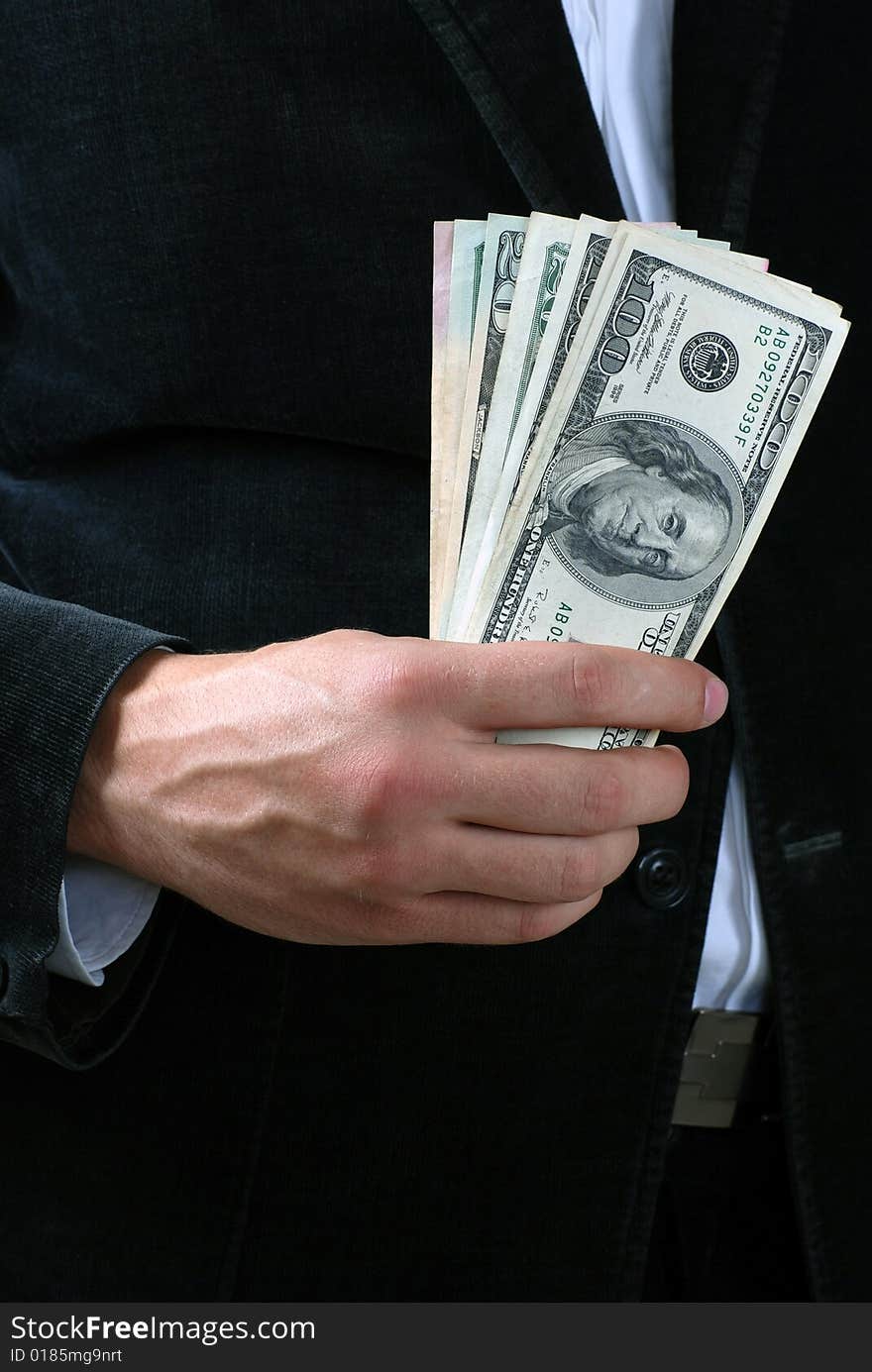 A man holding a stack of dollar banknotes. A man holding a stack of dollar banknotes