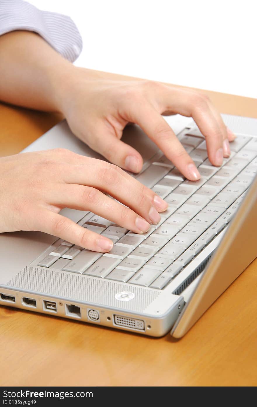 A person typing on a laptop keyboard