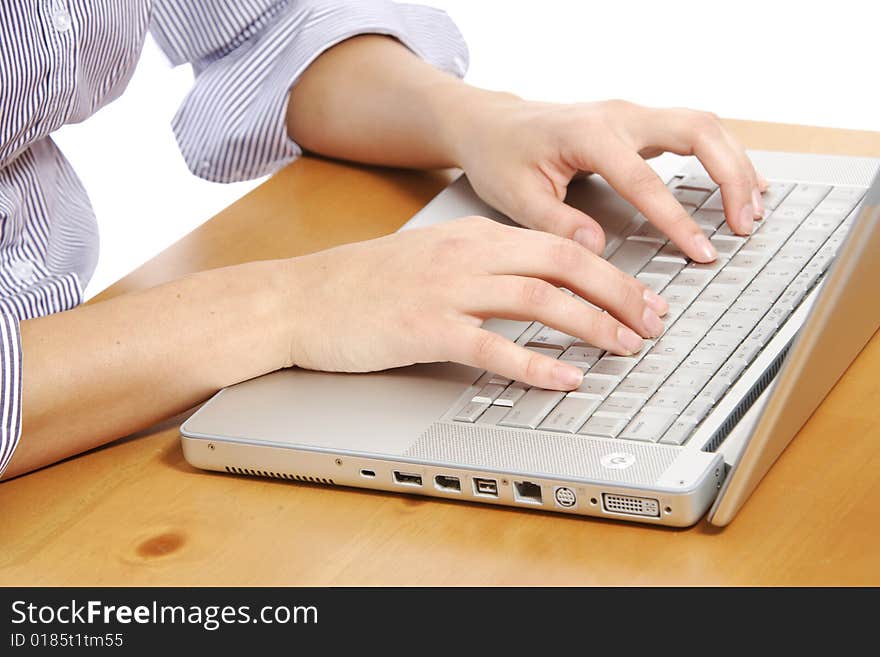 A person typing on a laptop keyboard