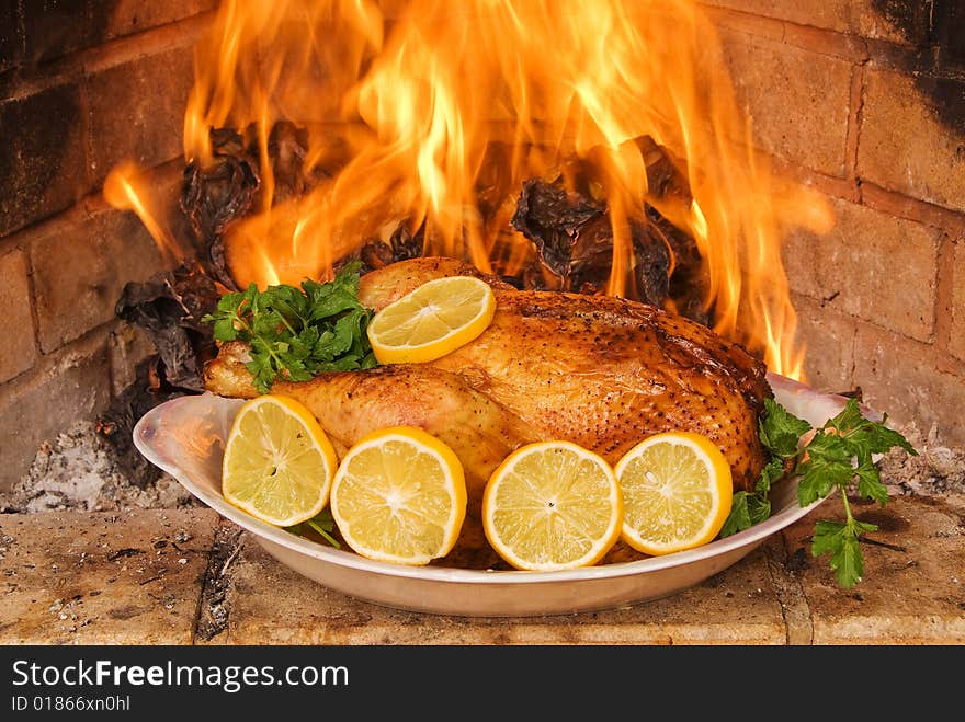 Hen a grill against a fireplace flame. A celebratory supper. Hen a grill against a fireplace flame. A celebratory supper.