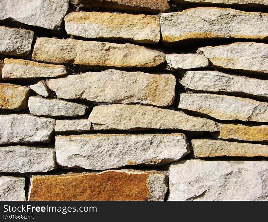 Irregular brick wall with various tint and forms of brick