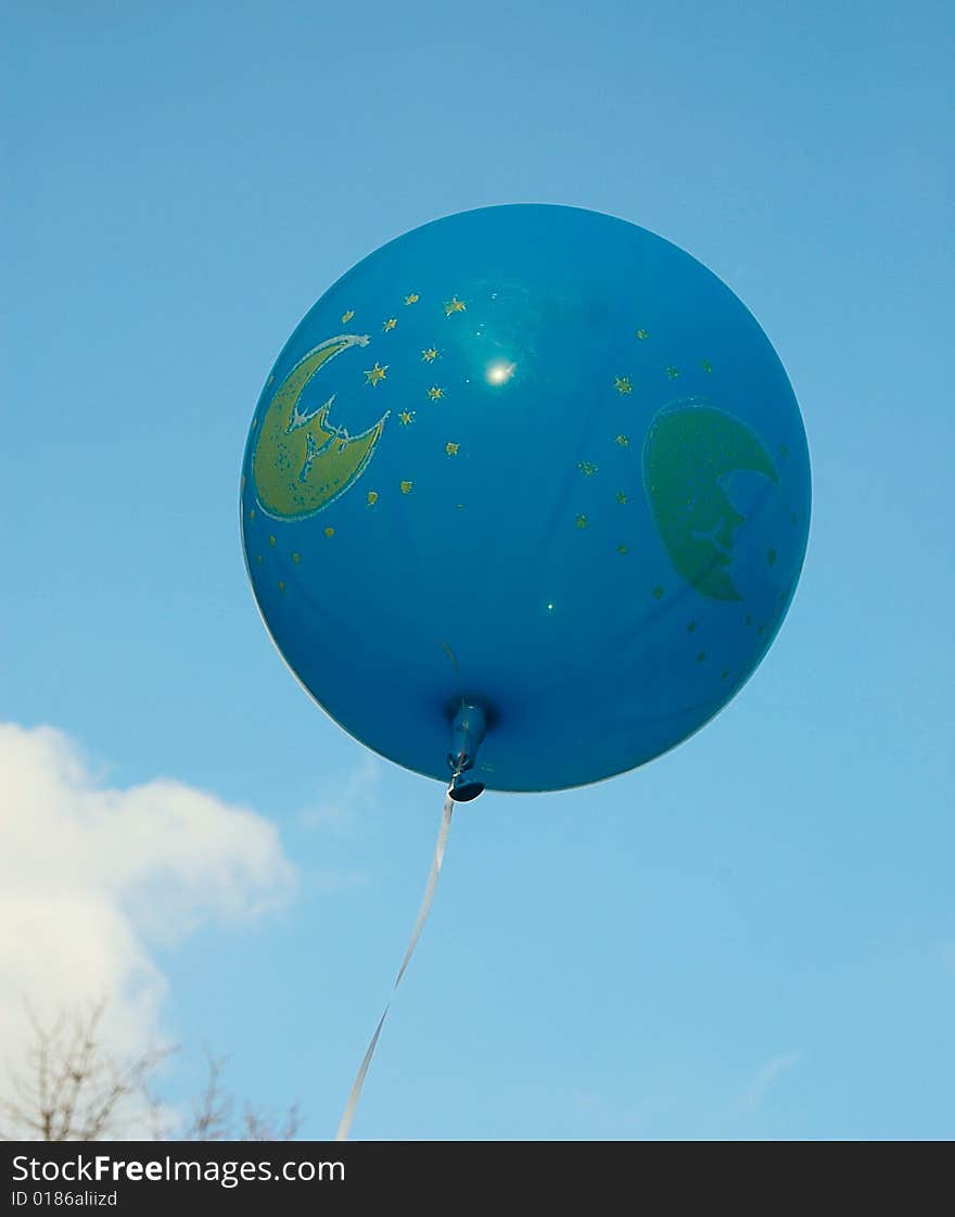 Blue ballon in the autumn sky. A ball is fastened a ribbon. Blue ballon in the autumn sky. A ball is fastened a ribbon.