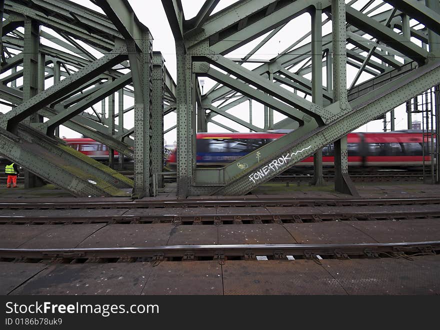 Man, Train and Bridge.
Hohenzollern Bridge in Cologne, Germany.