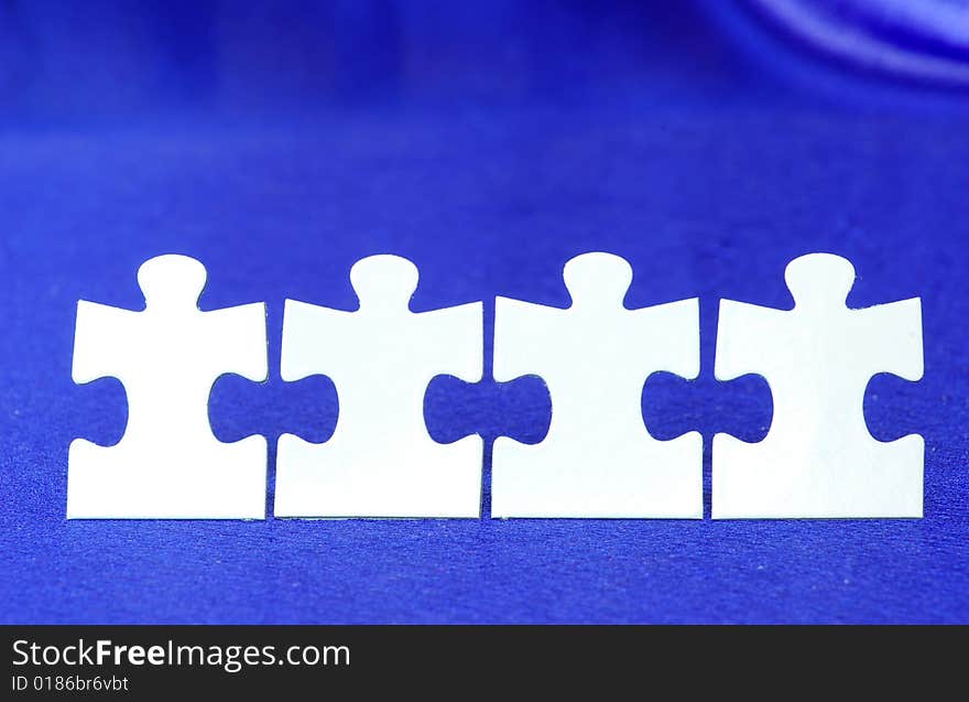 White puzzles isolated on a blue