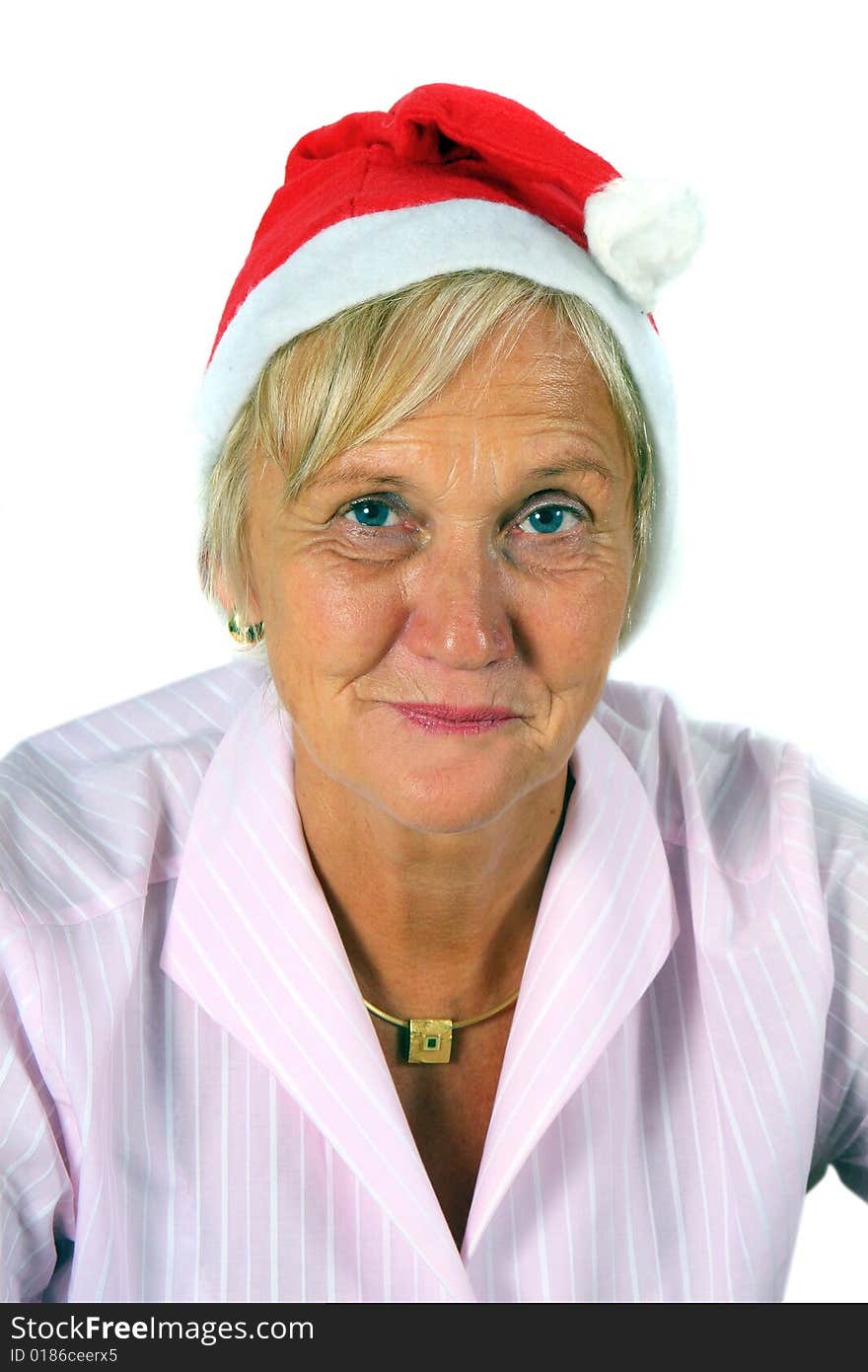 A businesswoman in her sixties with a Santa claus hat - smiling. Isolated over white. A businesswoman in her sixties with a Santa claus hat - smiling. Isolated over white.