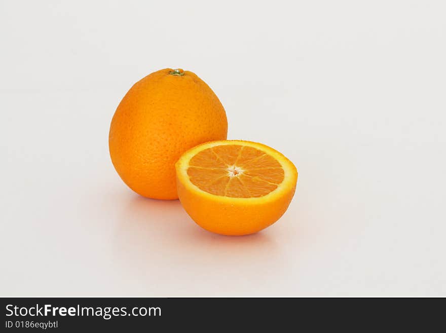 One and a halfe oranges on a white background. One and a halfe oranges on a white background.