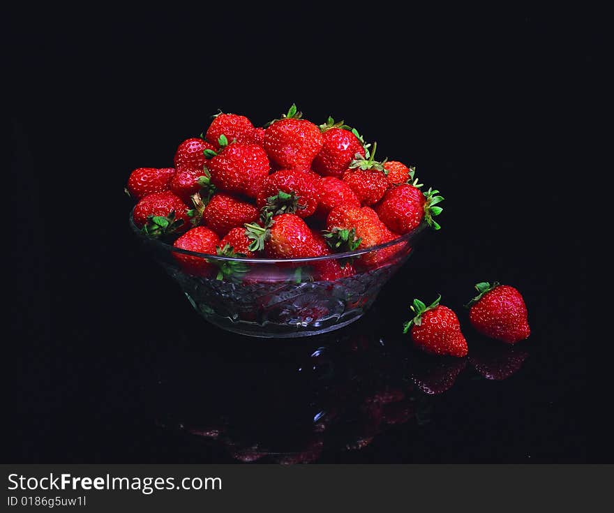 Red strawberry against black background