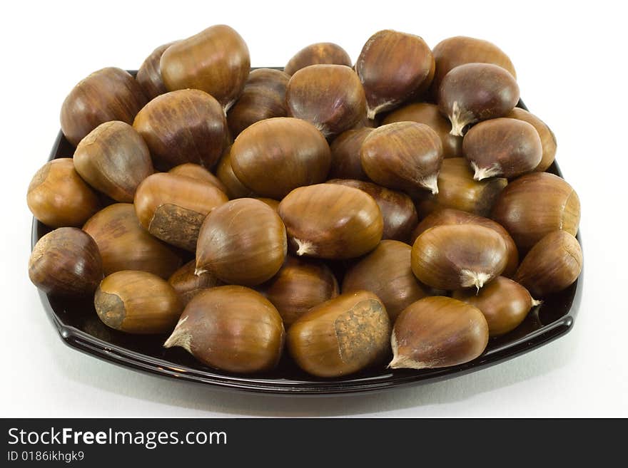 Chestnuts On Dark Plate Isol