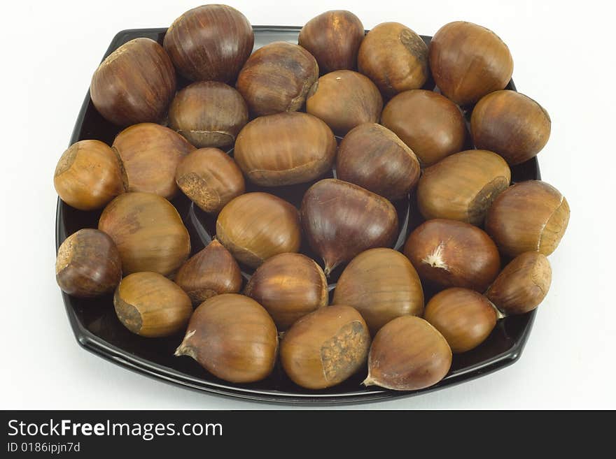 Chestnuts On Dark Plate Isol