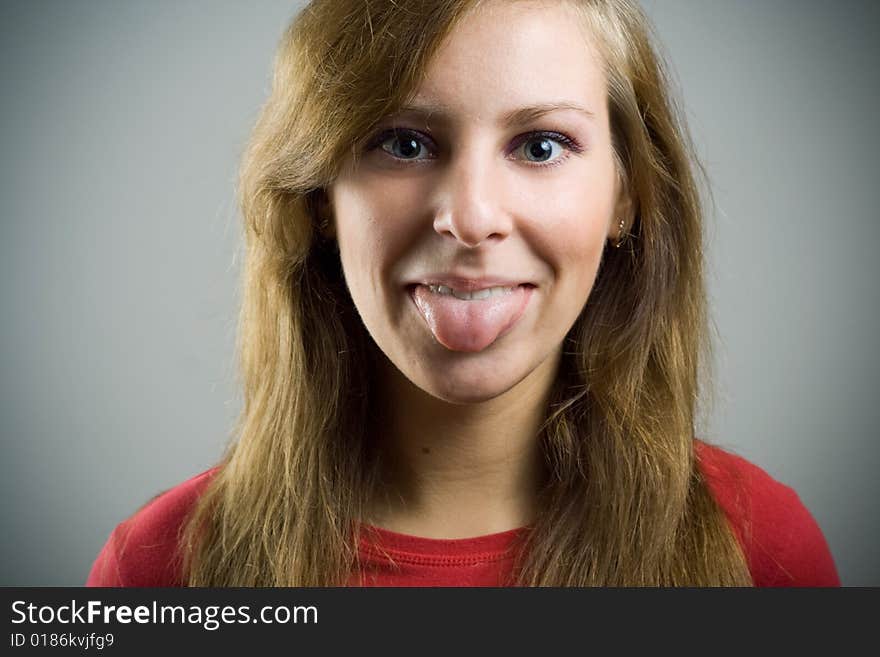 Girl put out tongue and looking at camera. Girl put out tongue and looking at camera.