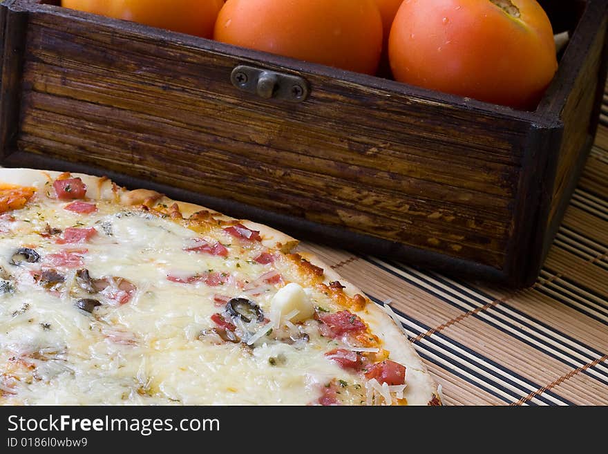 Tasty gorgonzola cheese pizza with black olives on red background