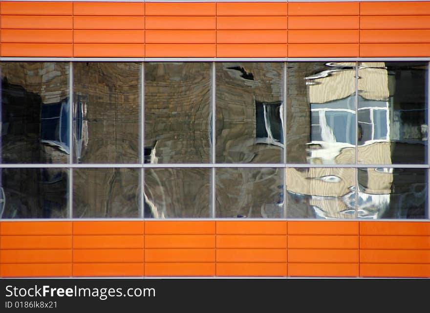 Distorted reflections of a brick wall in windows. Distorted reflections of a brick wall in windows