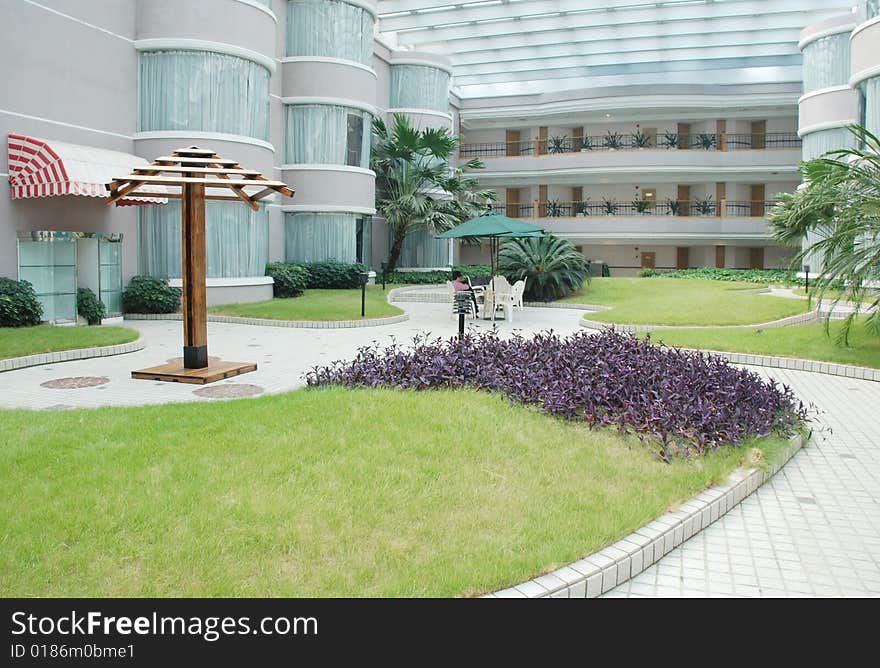 The indoor garden in a resort hotel patio with glass roof.