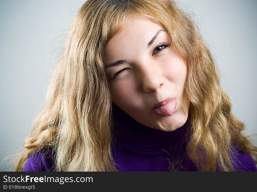 Girl put out tongue and wink. Girl put out tongue and wink.