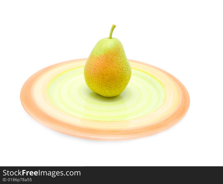 Green pear on a plate over white