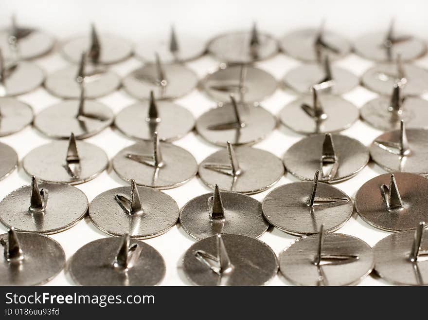 Rows of sharp steel thumbtacks as a background (vintage style)