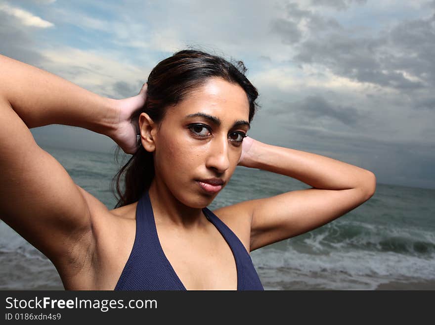 Young female with her arms behind her head. Young female with her arms behind her head