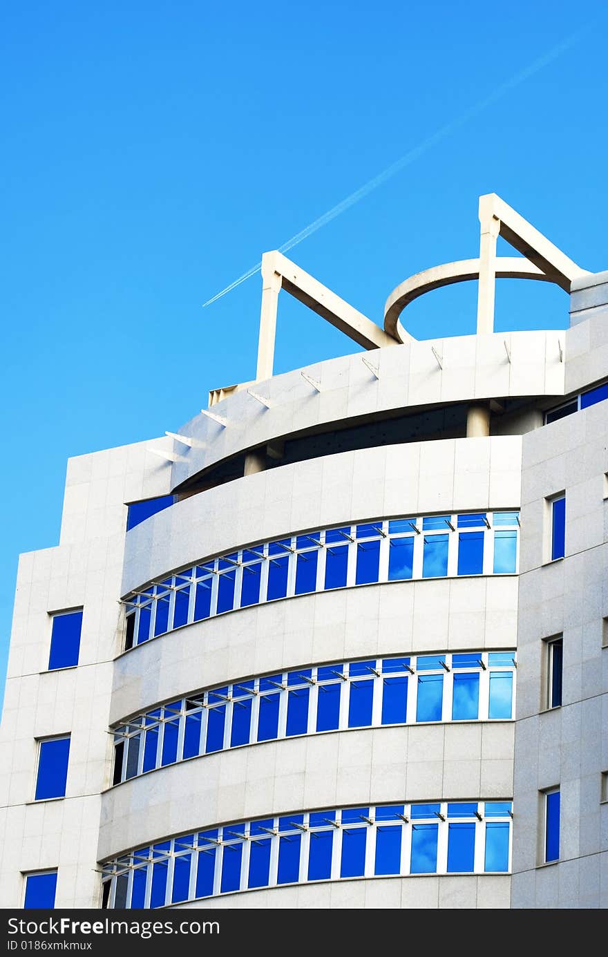 Modern building with reflection of blue sky on windows. Modern building with reflection of blue sky on windows