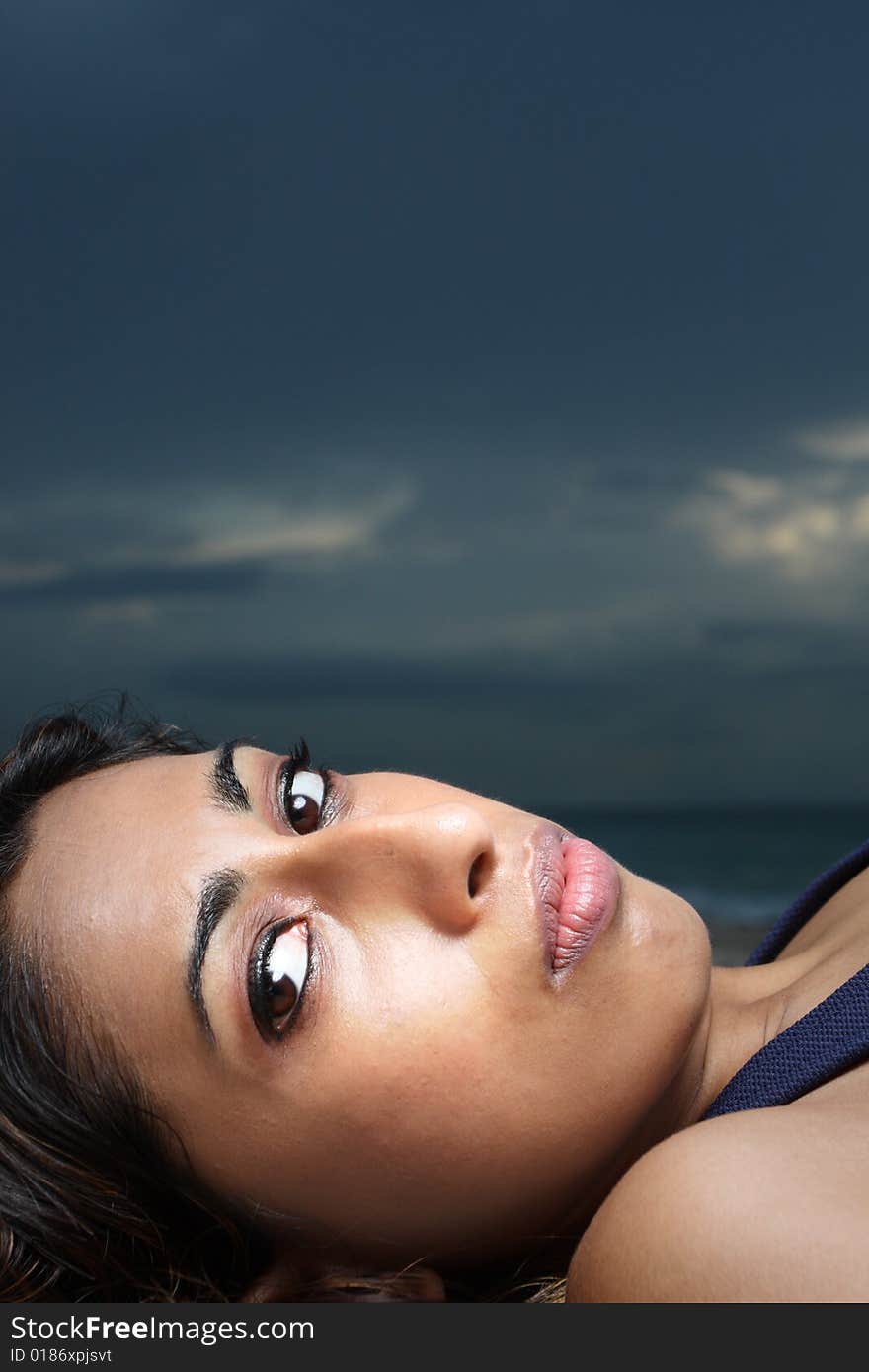 Headshot of a woman laying down and looking at the camera. Headshot of a woman laying down and looking at the camera