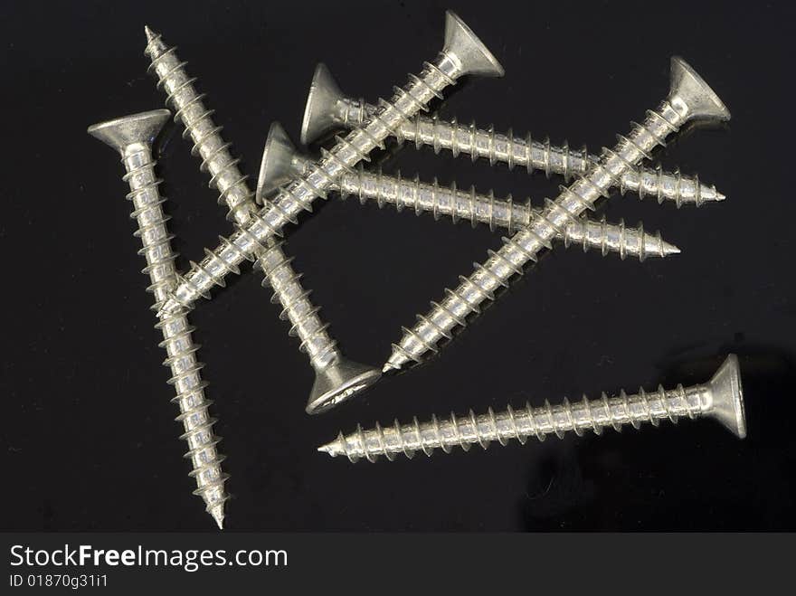 Macro shot of screws on black background