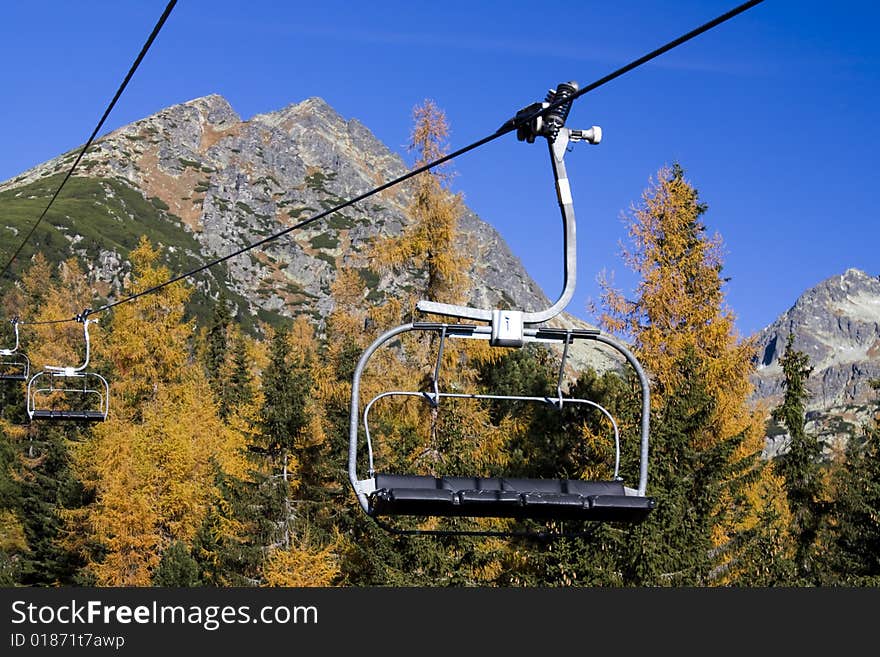 Chairlift climbing on fall mountains. Chairlift climbing on fall mountains