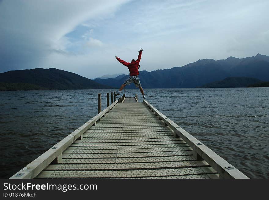 A man running, jumping and waving hands in the air. A man running, jumping and waving hands in the air