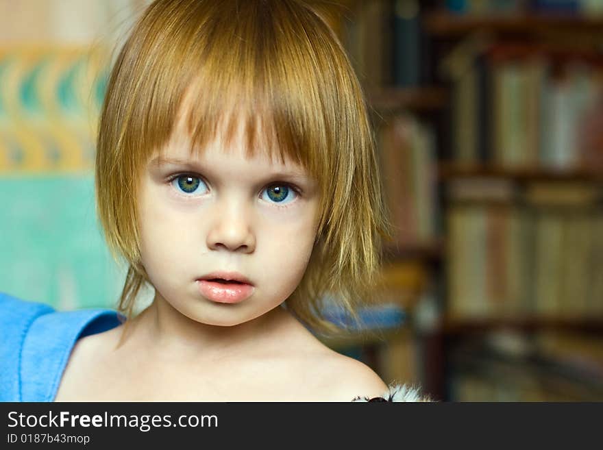 Portrait of small beauty girl with green-blue eyes and red-haired.