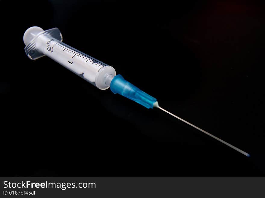 Medical Syringe On Black Background