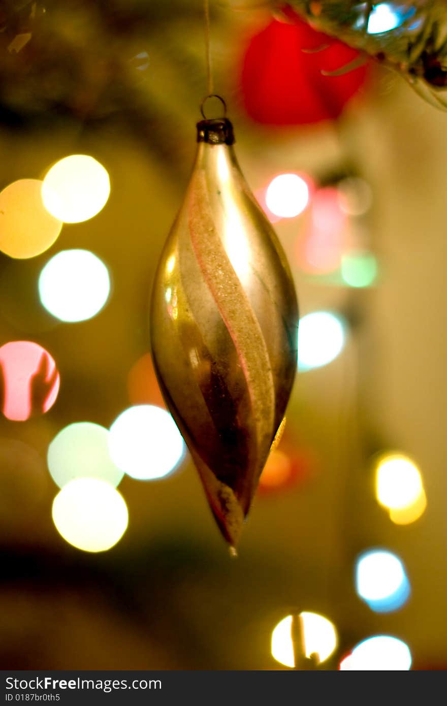 Christmas background with golden globe and tree lights in soft focus. Christmas background with golden globe and tree lights in soft focus