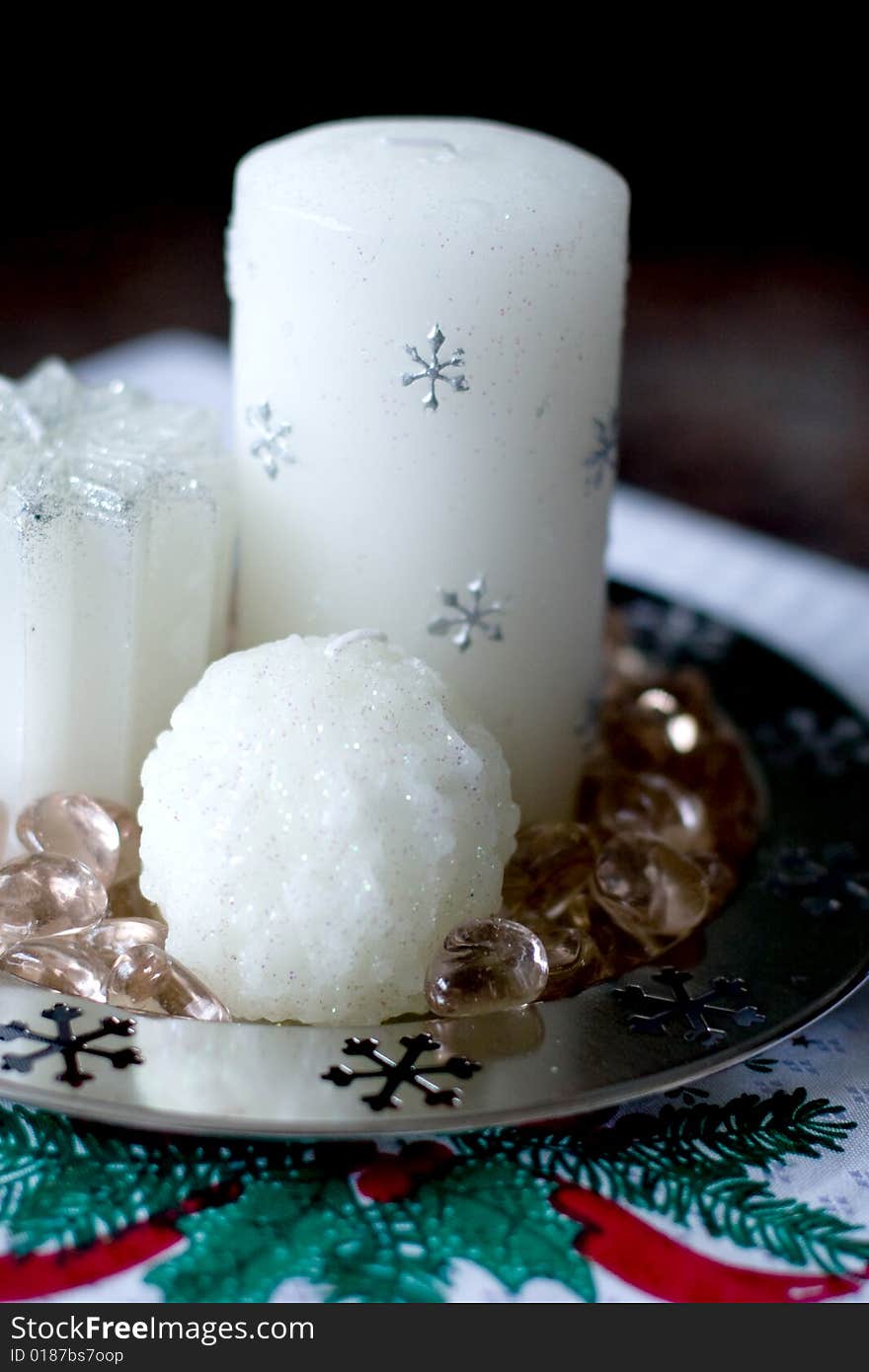 Detail of whte christmas candles sitting on a table. Detail of whte christmas candles sitting on a table