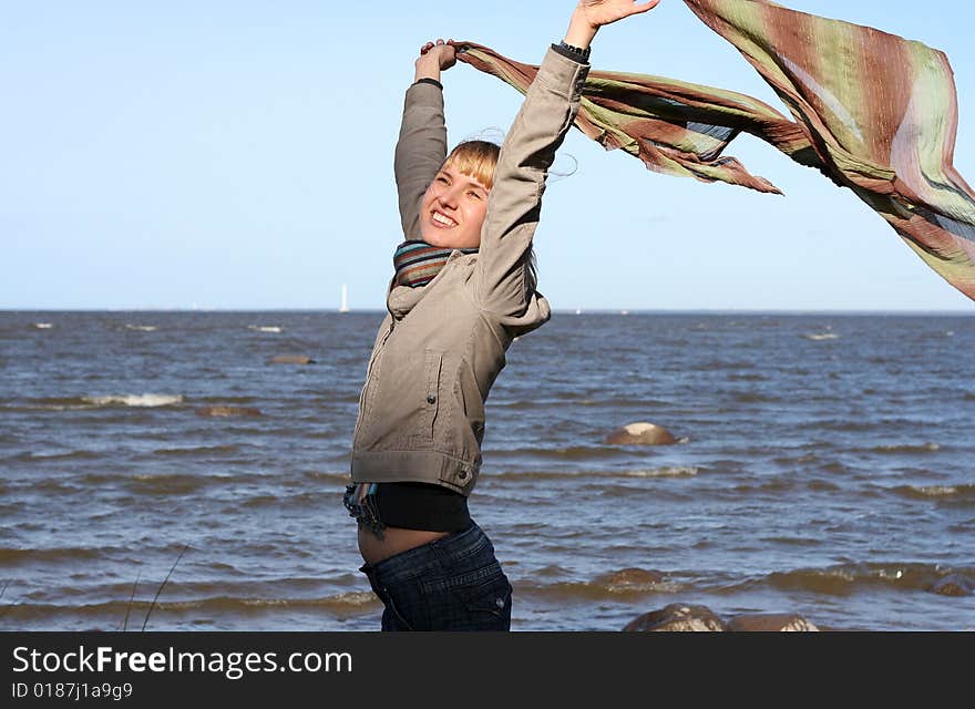 Blond woman with scarf. Windy day.