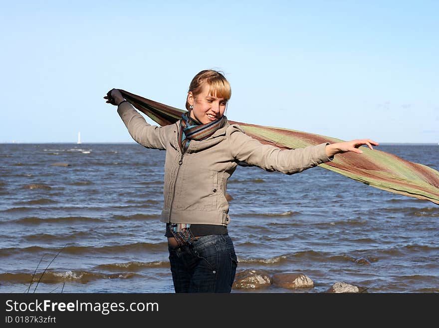 Blond woman with scarf. Windy day.