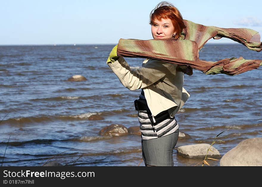 Red haired woman with scarf. Windy day.