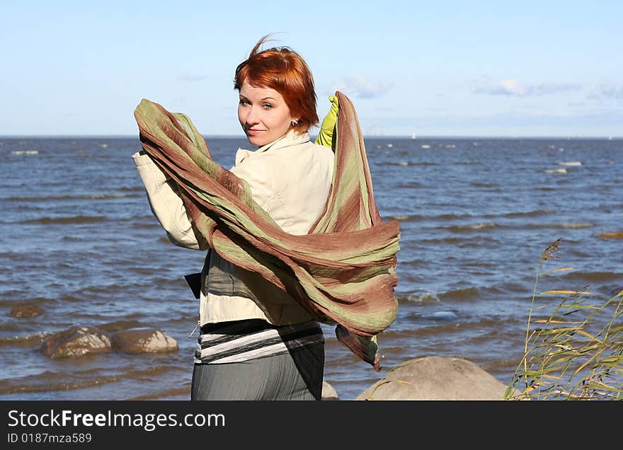 Red haired woman with scarf. Windy day.